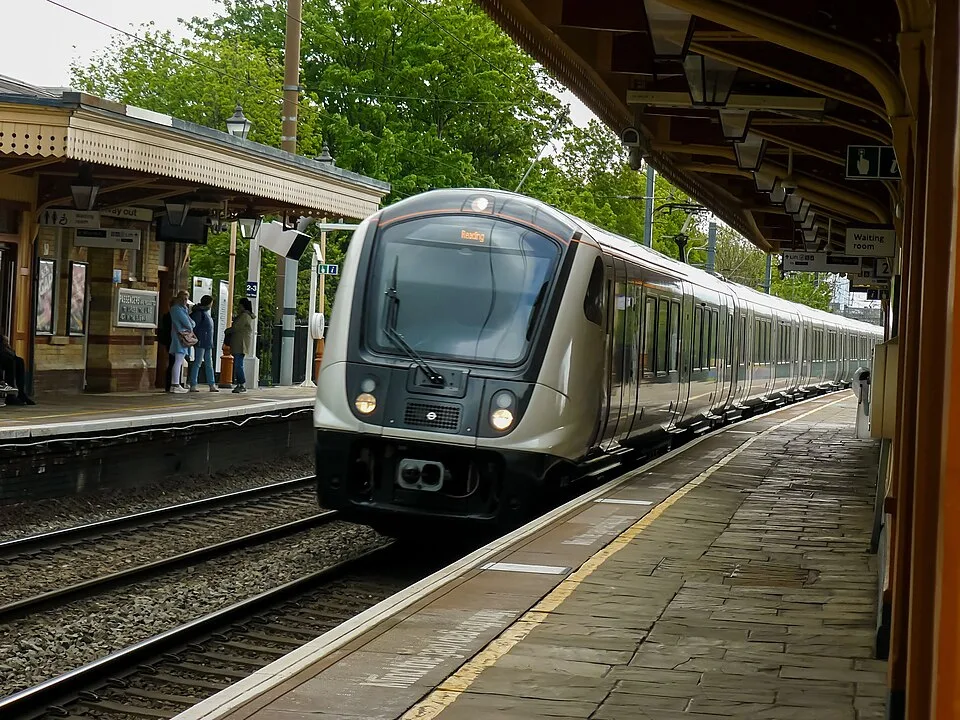 Elizabeth line train arriving at a station platform on the route to Heathrow