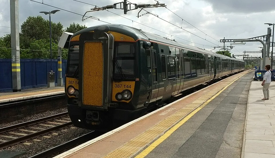 Train standing at a station platform on the rail route towards Heathrow