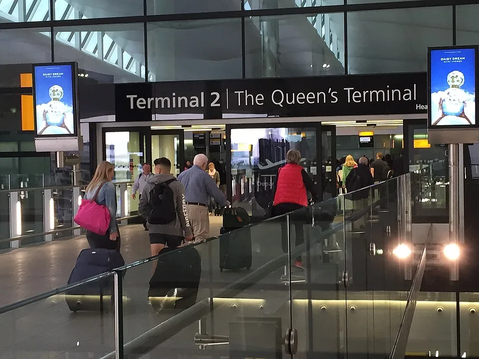 Terminal 2 departures entrance at Heathrow Airport with passengers and luggage
